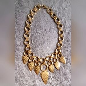Bib style gold toned metal petal necklace. 17" long aprox.